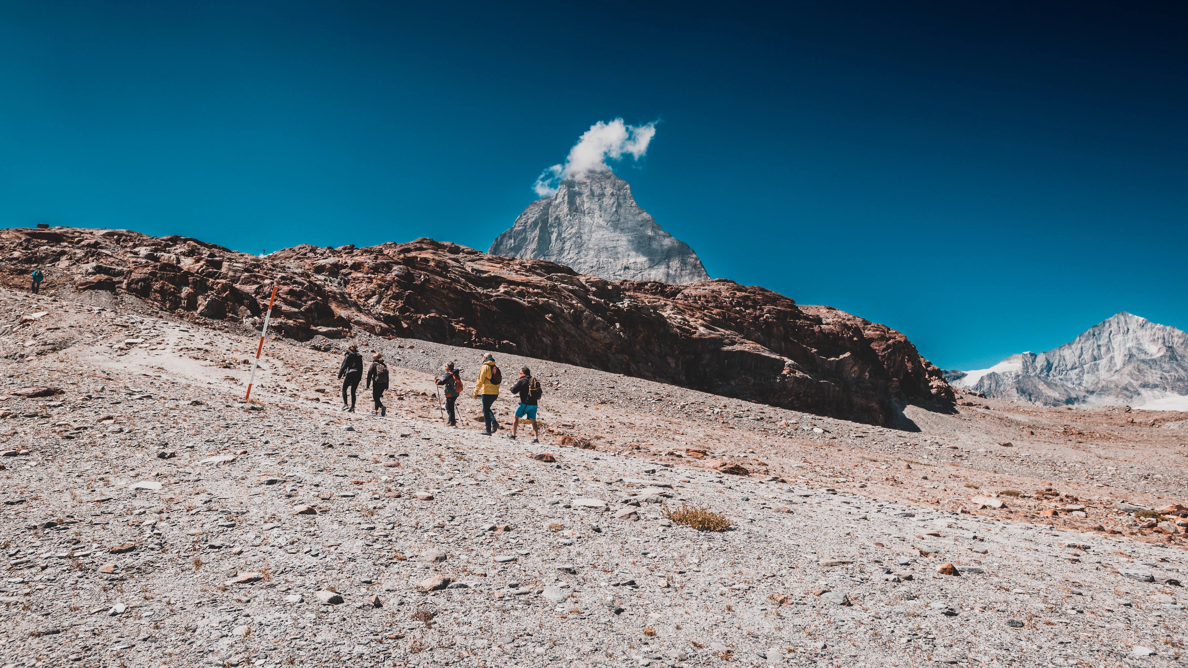 A group walking across the snow at Trockener Steg above Zermatt