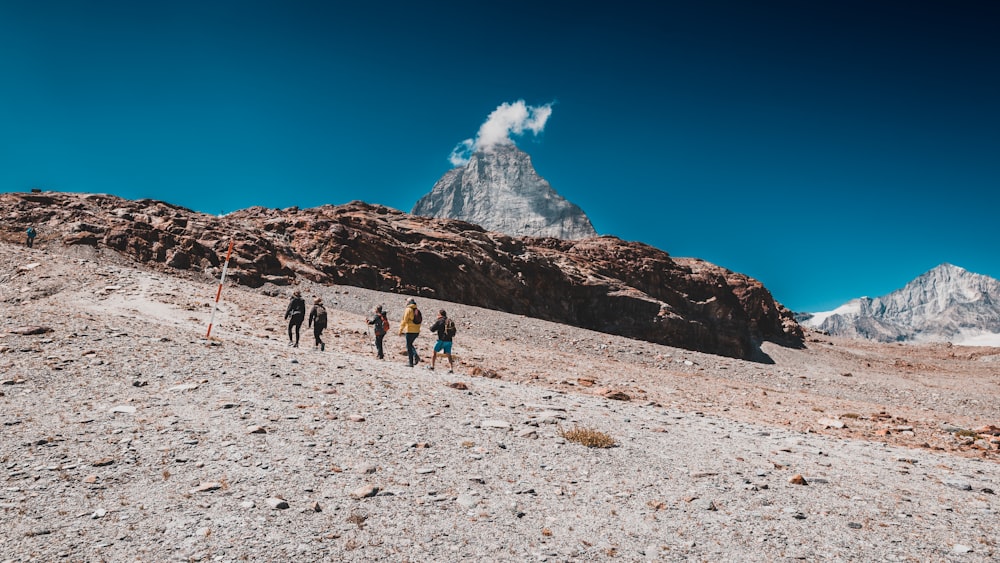 a group of people walking on a snowy mountain