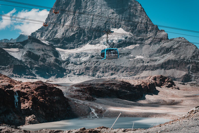 A cable car climbing from Trockener Steg toward the Klein Matterhorn above Zermatt