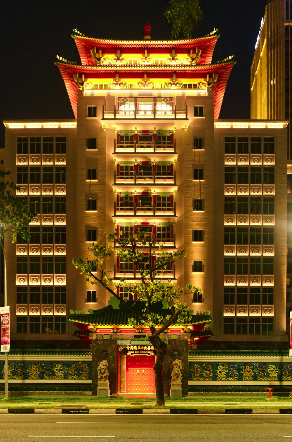 a tall building with a tree in front of it