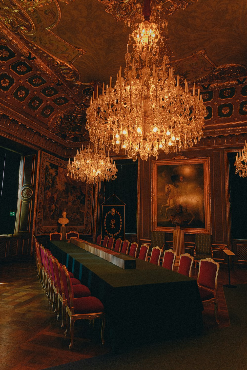 a room with a chandelier and chairs