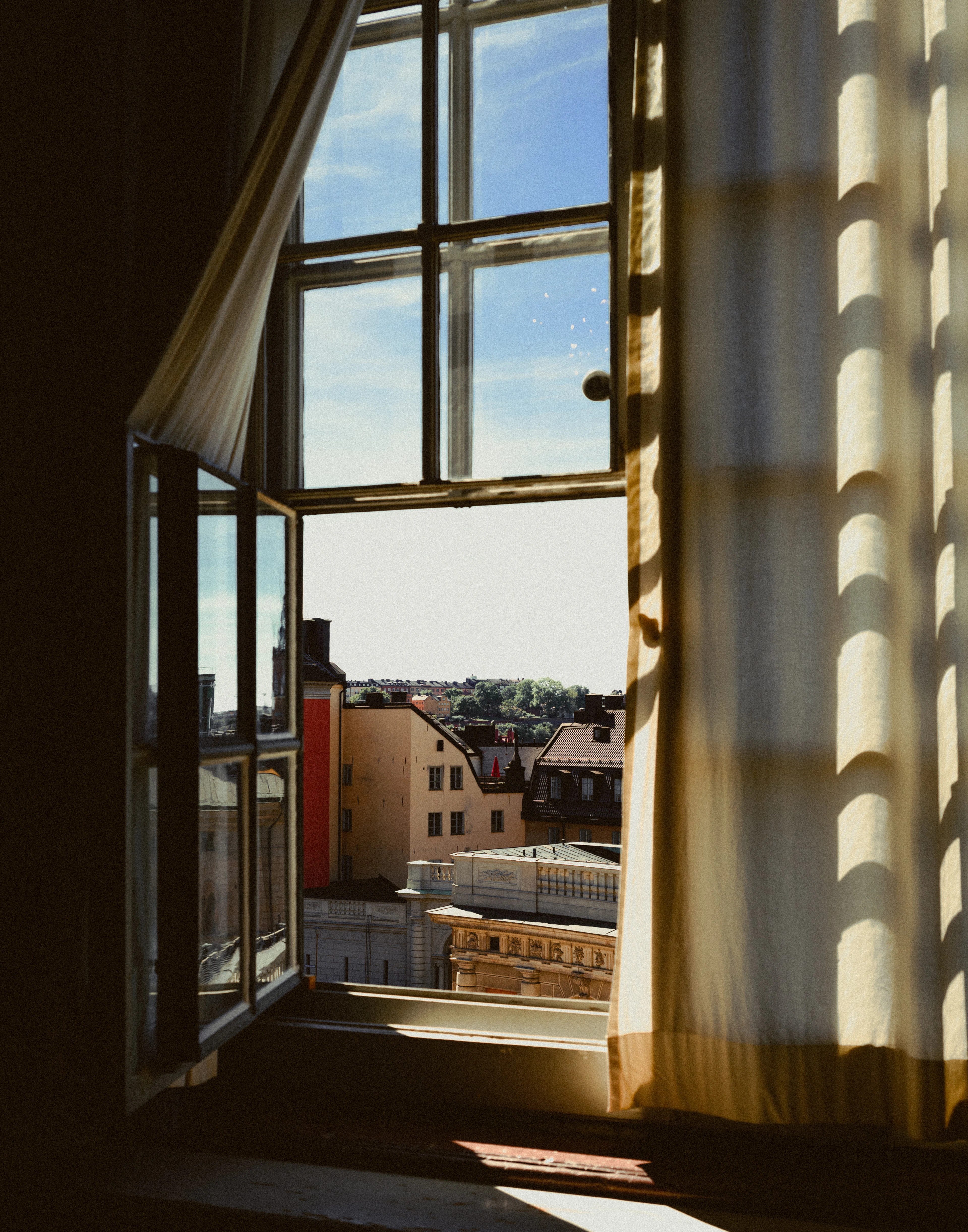 Rooftops of Gamla Stan seen through a window