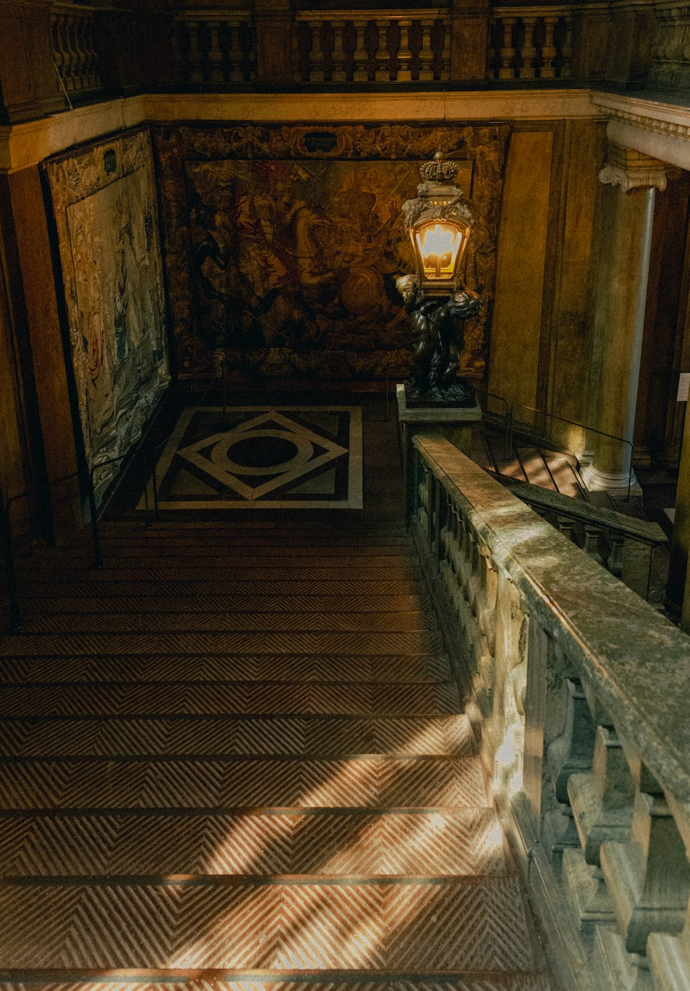 a staircase with a lamp on the side