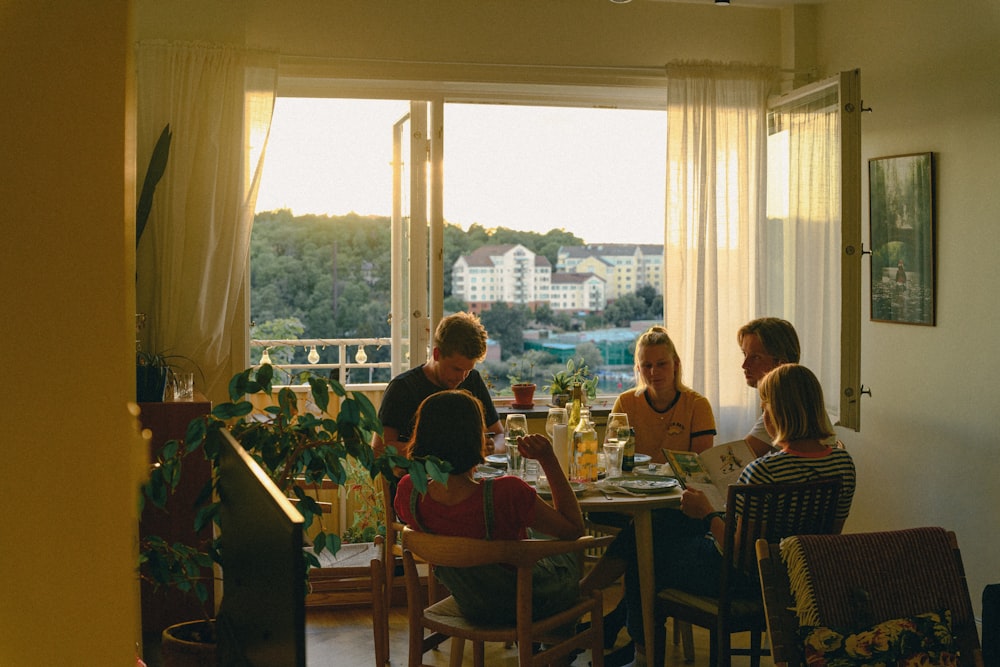 a group of people sitting around a table