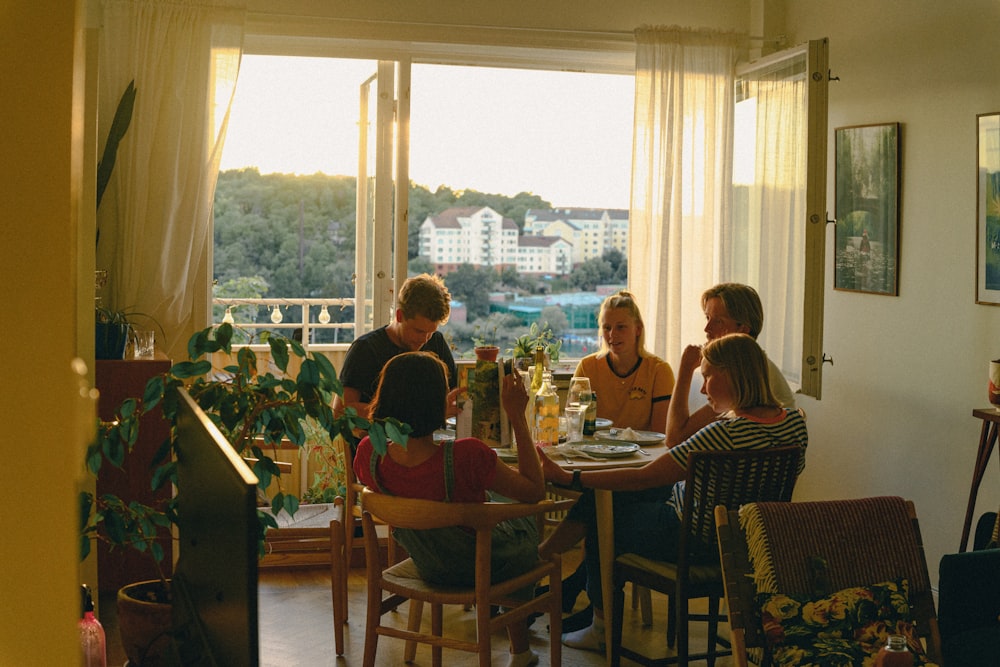 a group of people sitting around a table