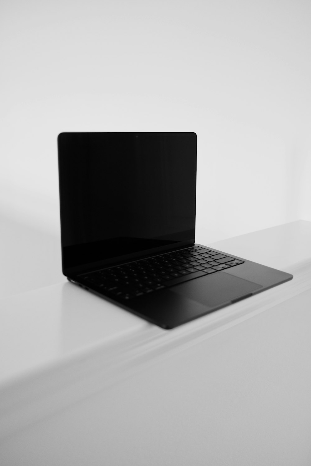 a black laptop on a white surface