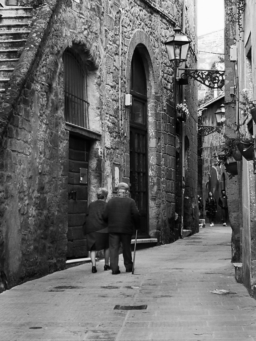 a couple walking down a street