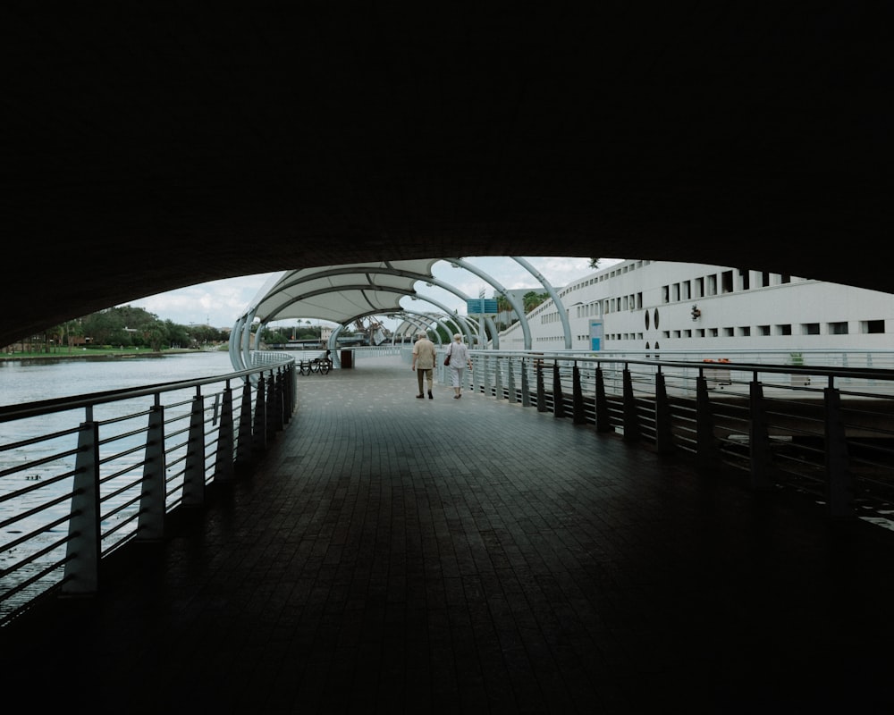 a couple walking on a bridge