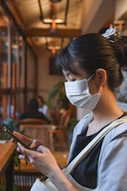 A cozy small restaurant manager checking inventory and sales reports on a smartphone.