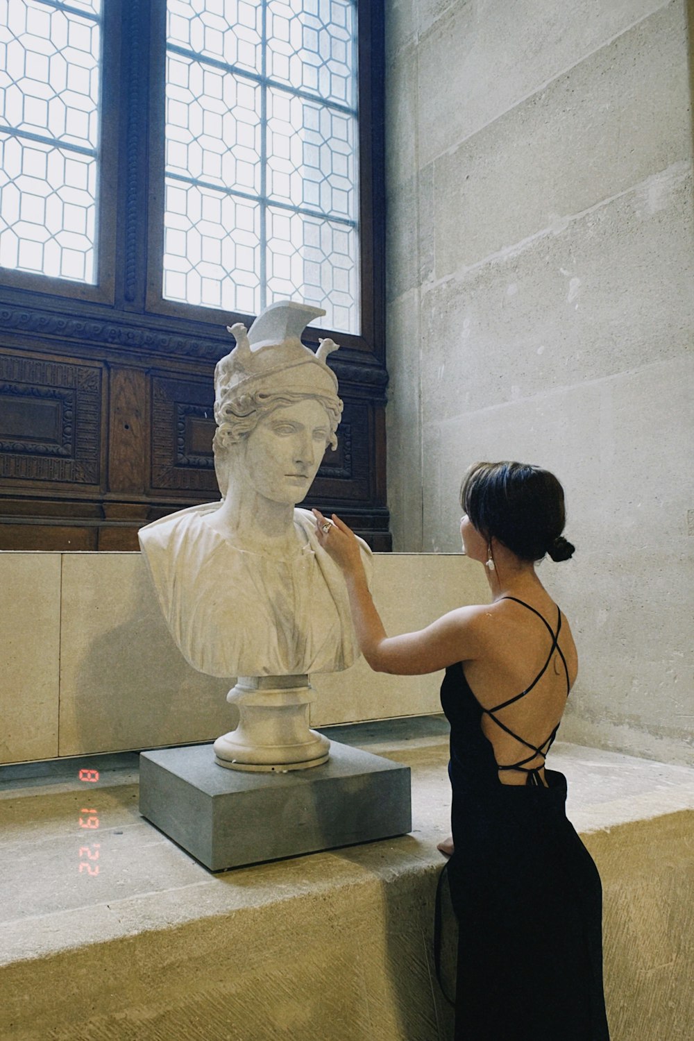 a woman touching a statue