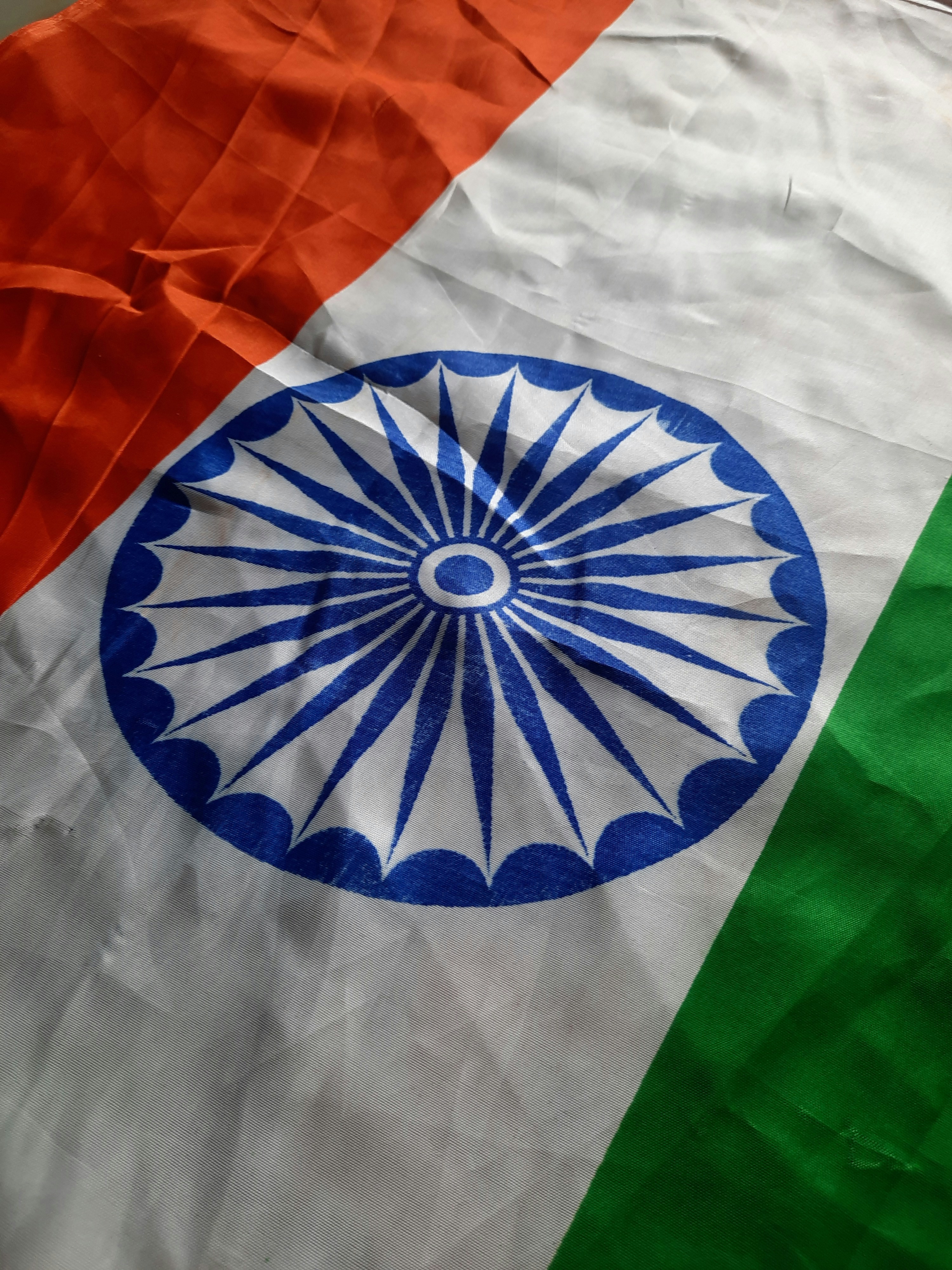 Indian flag with orange, white, and green horizontal stripes and blue Ashoka Chakra wheel in center