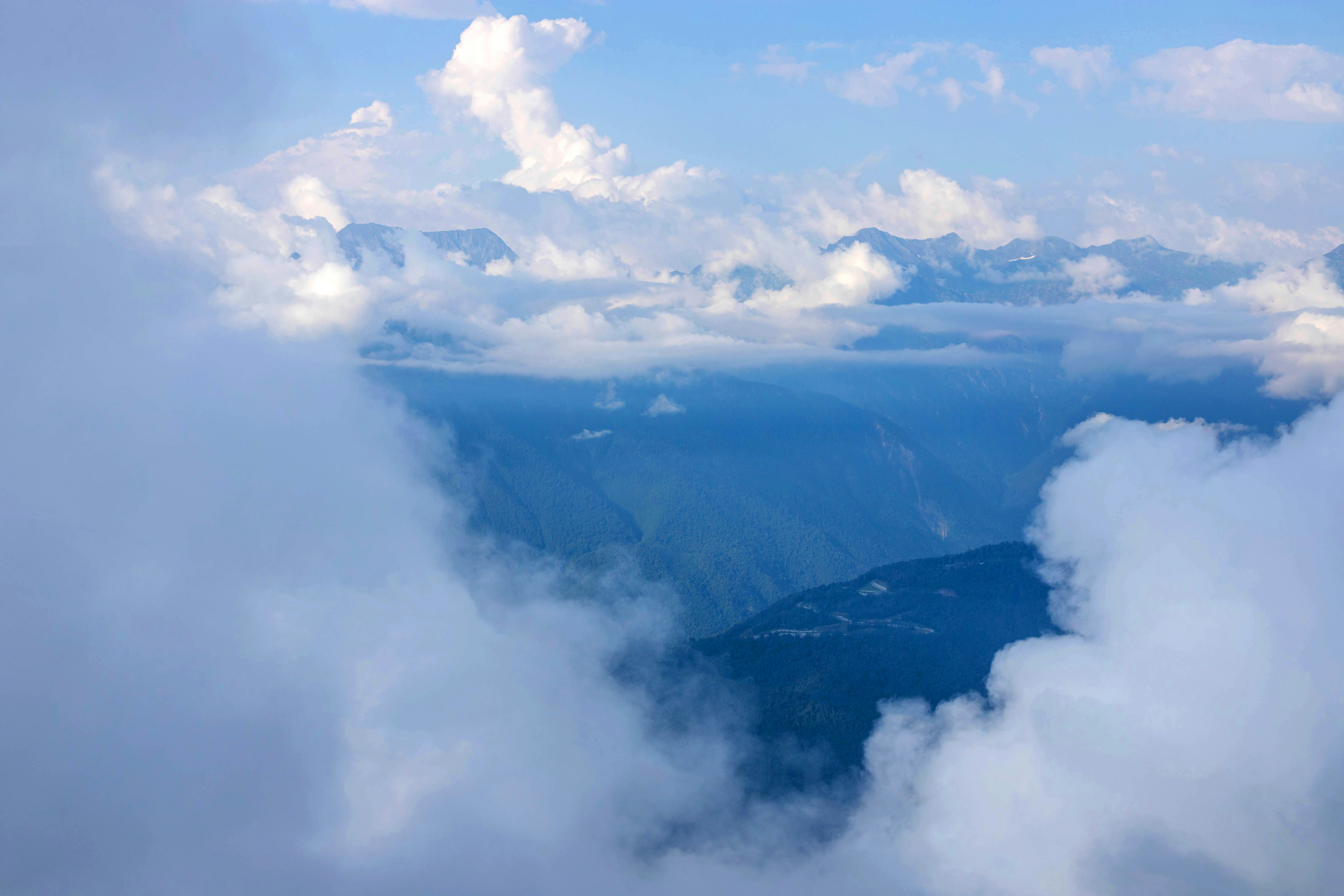 Clouds float among the mountains