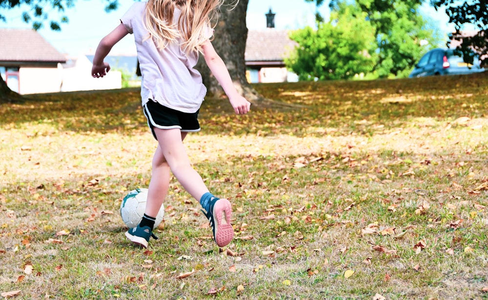 a girl running on grass