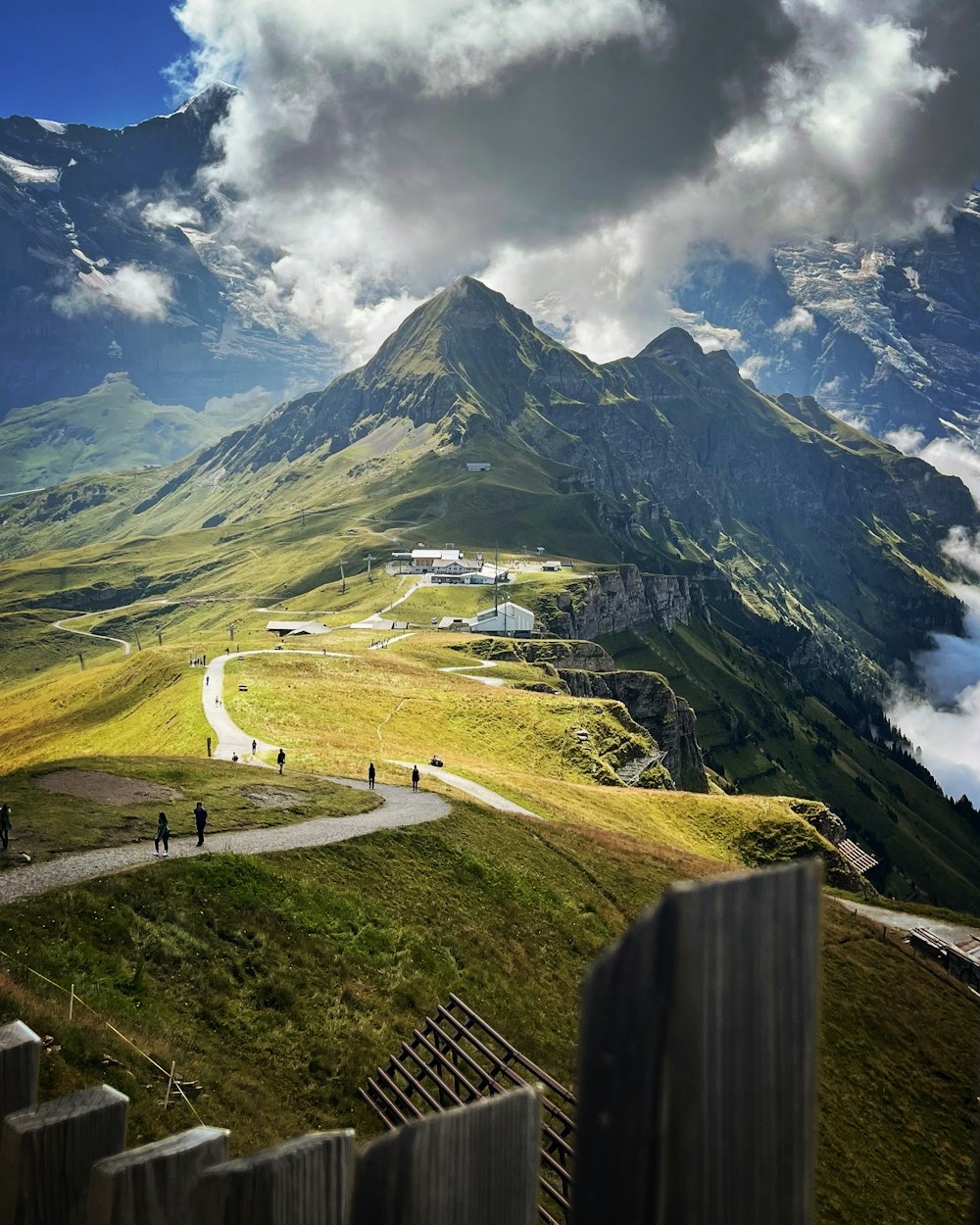 a mountain with a road and people walking on it