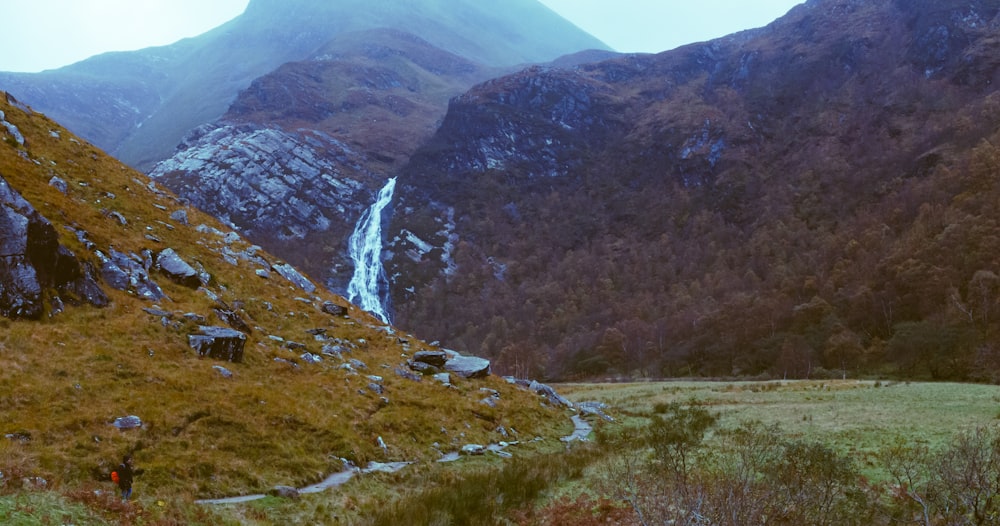 a waterfall in a valley