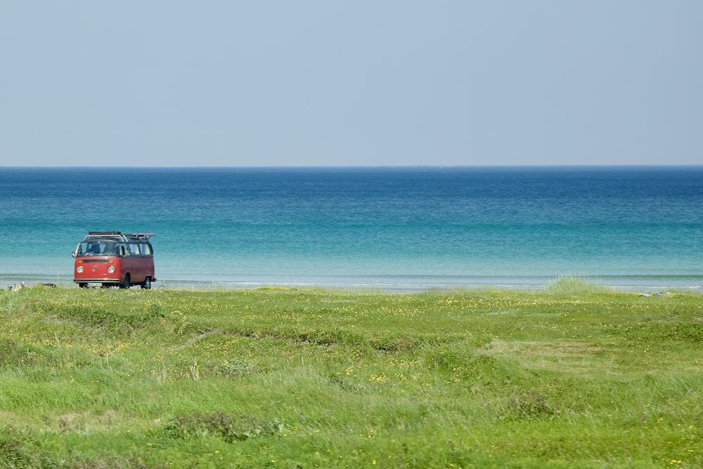 a red car parked on a beach