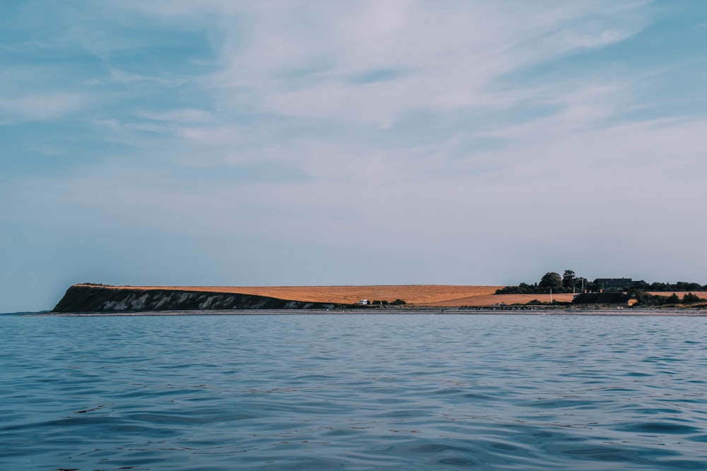 a body of water with land in the background