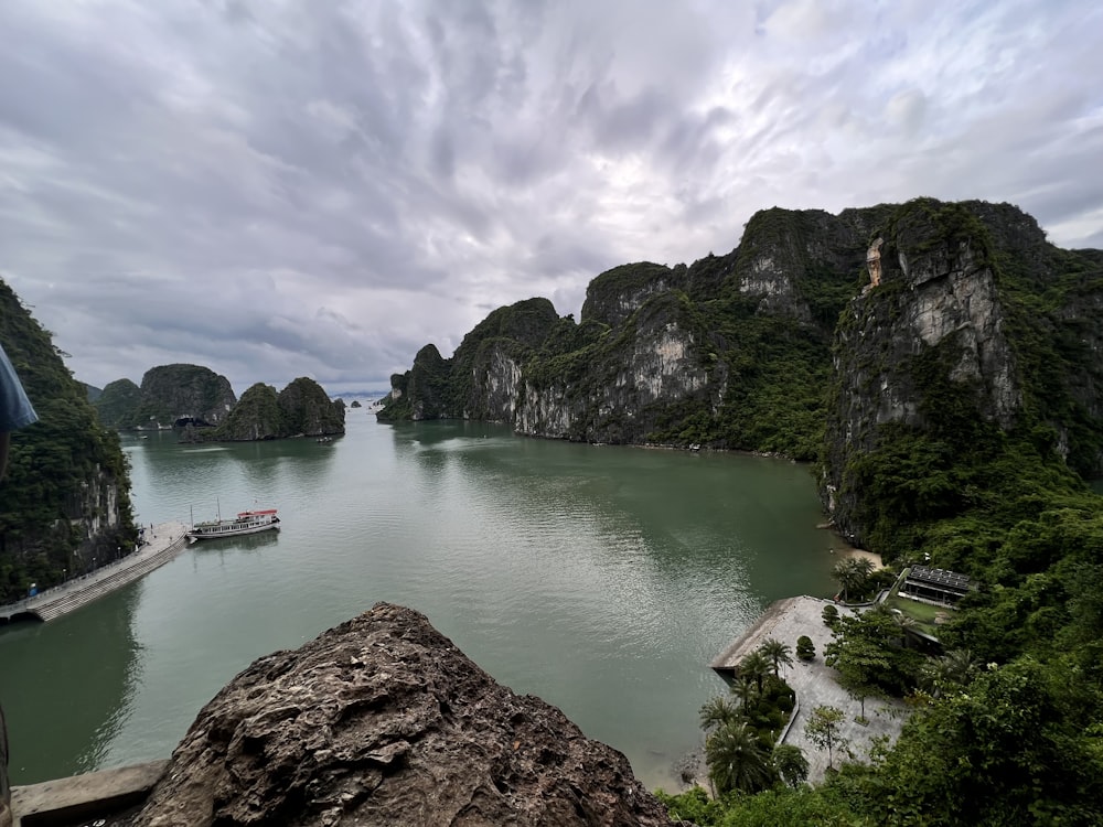 a body of water with a boat in it and a bridge over it