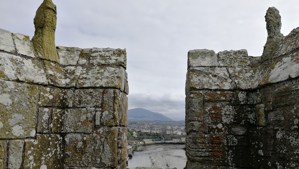 stone structures with a body of water in the background