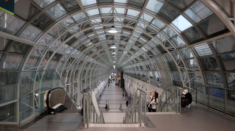 a large glass building with people walking around with National Museum of Scotland in the background