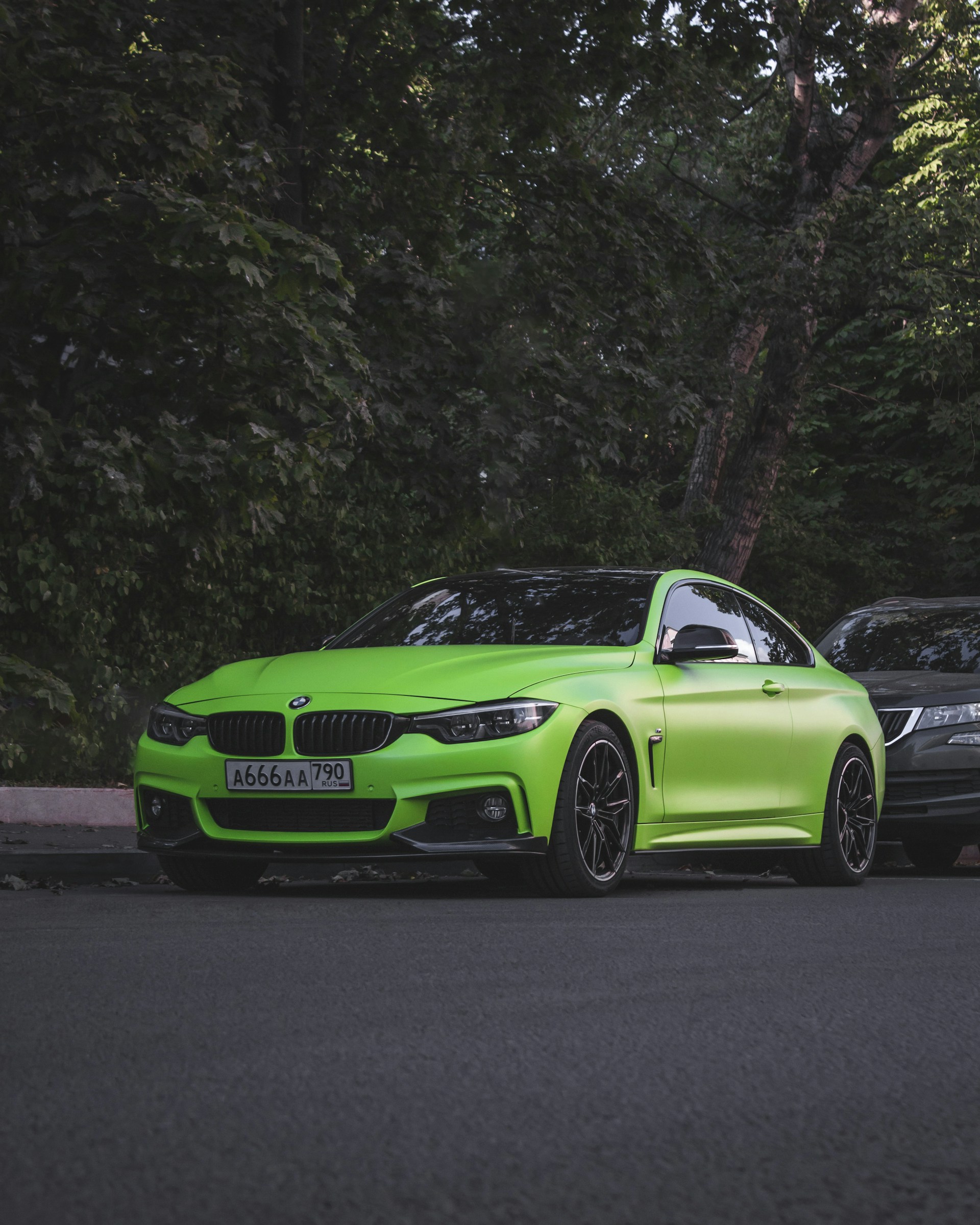 a green sports car parked on the side of the road