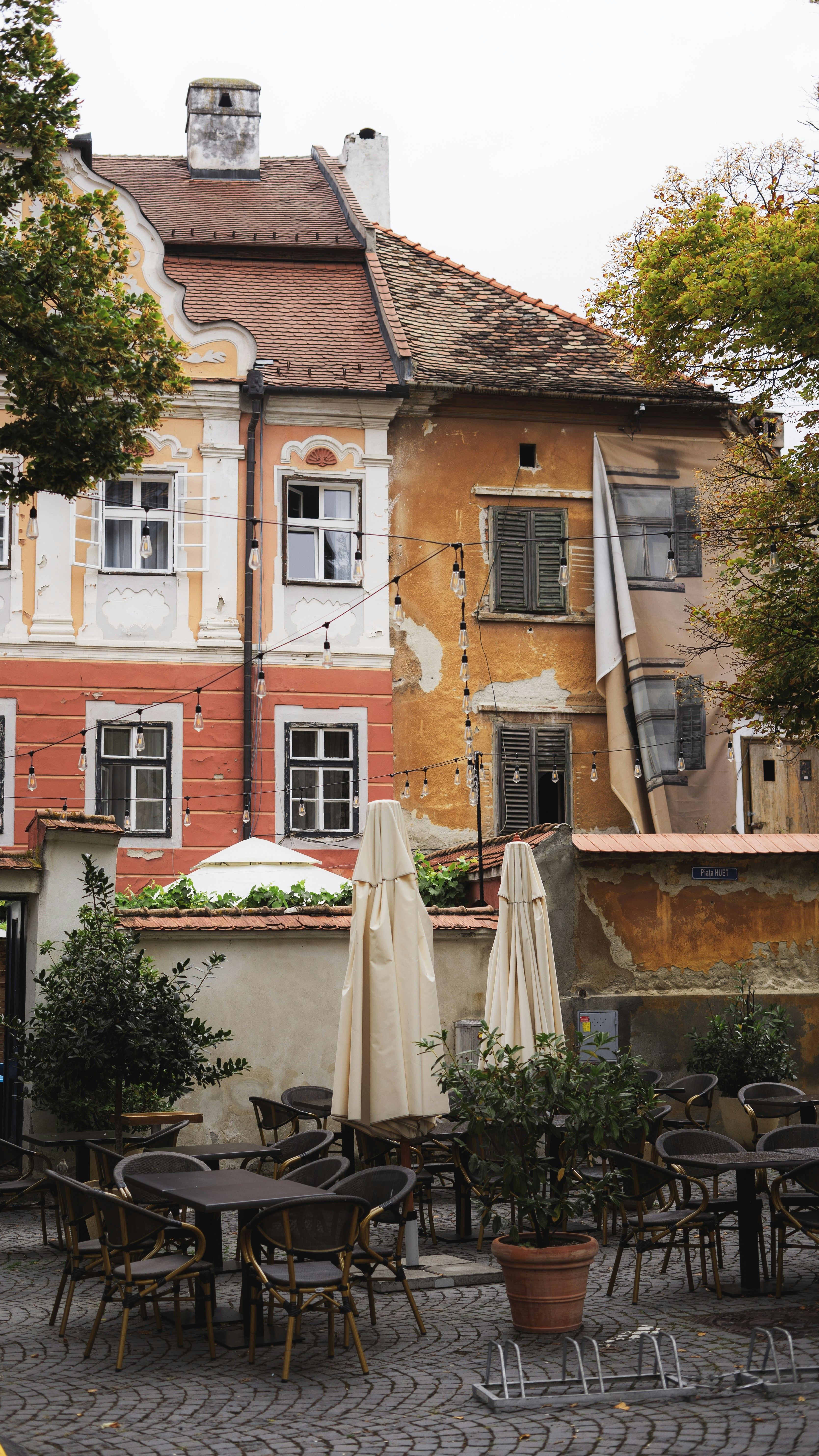 a brick building with tables and chairs outside