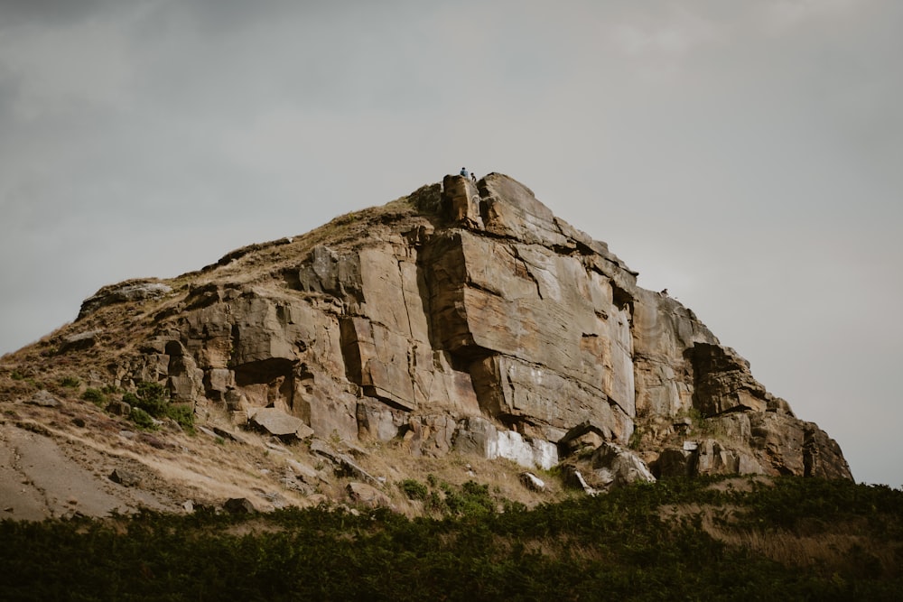 a rocky mountain with a person on it