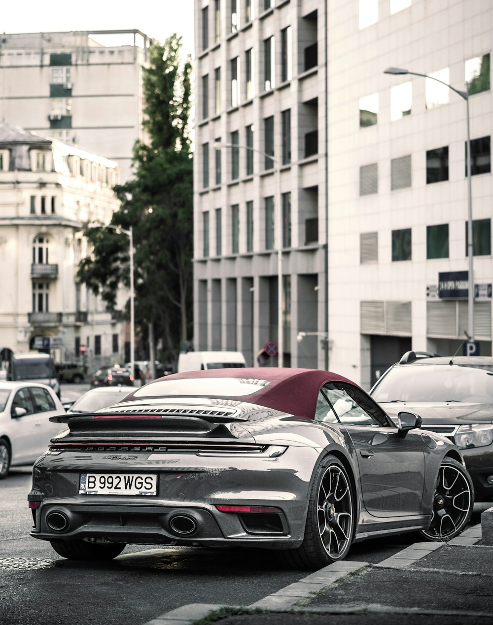 a black sports car parked on the side of a street