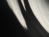 Abstract black and white image showing shadows and light playing on textured surfaces.