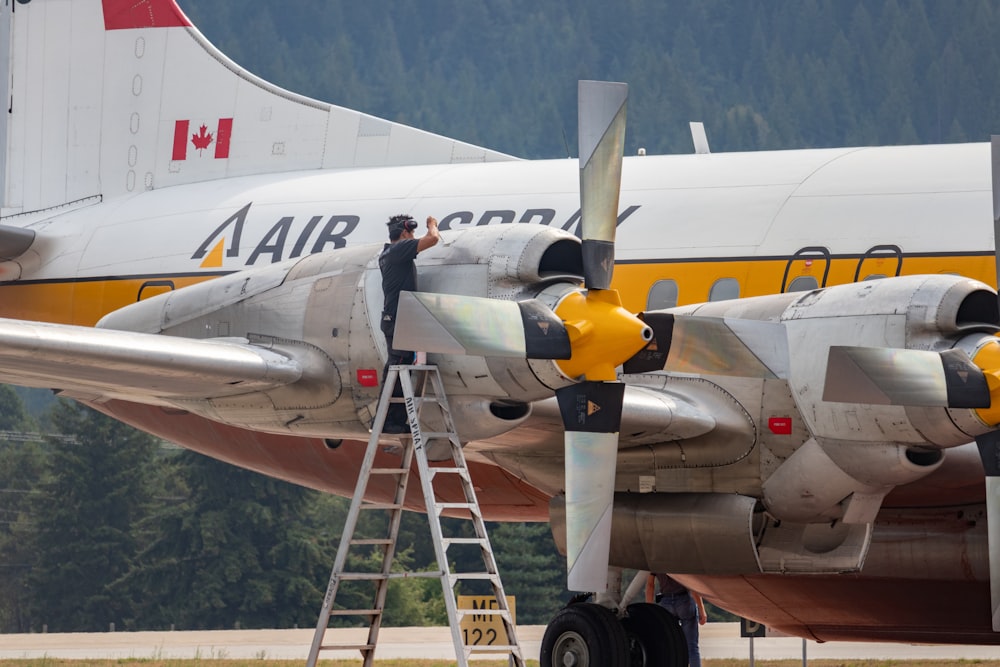 a person standing on the stairs of a plane