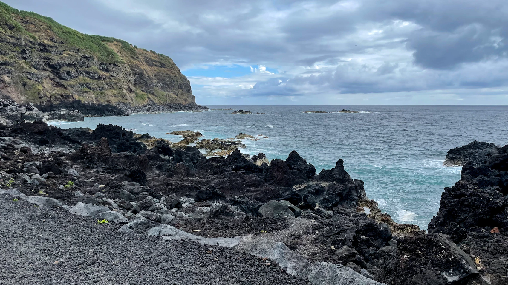 Dark volcanic rock meeting the Atlantic Ocean in the Azores