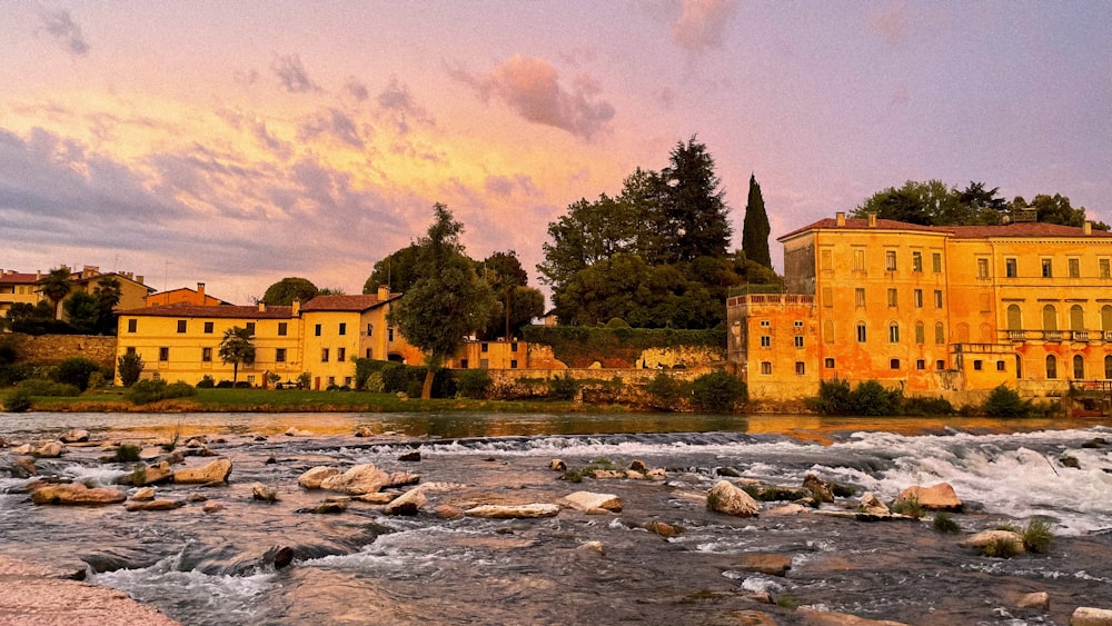 a river with rocks and buildings along it