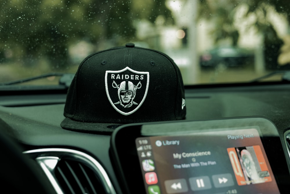 a car dashboard with a black hat