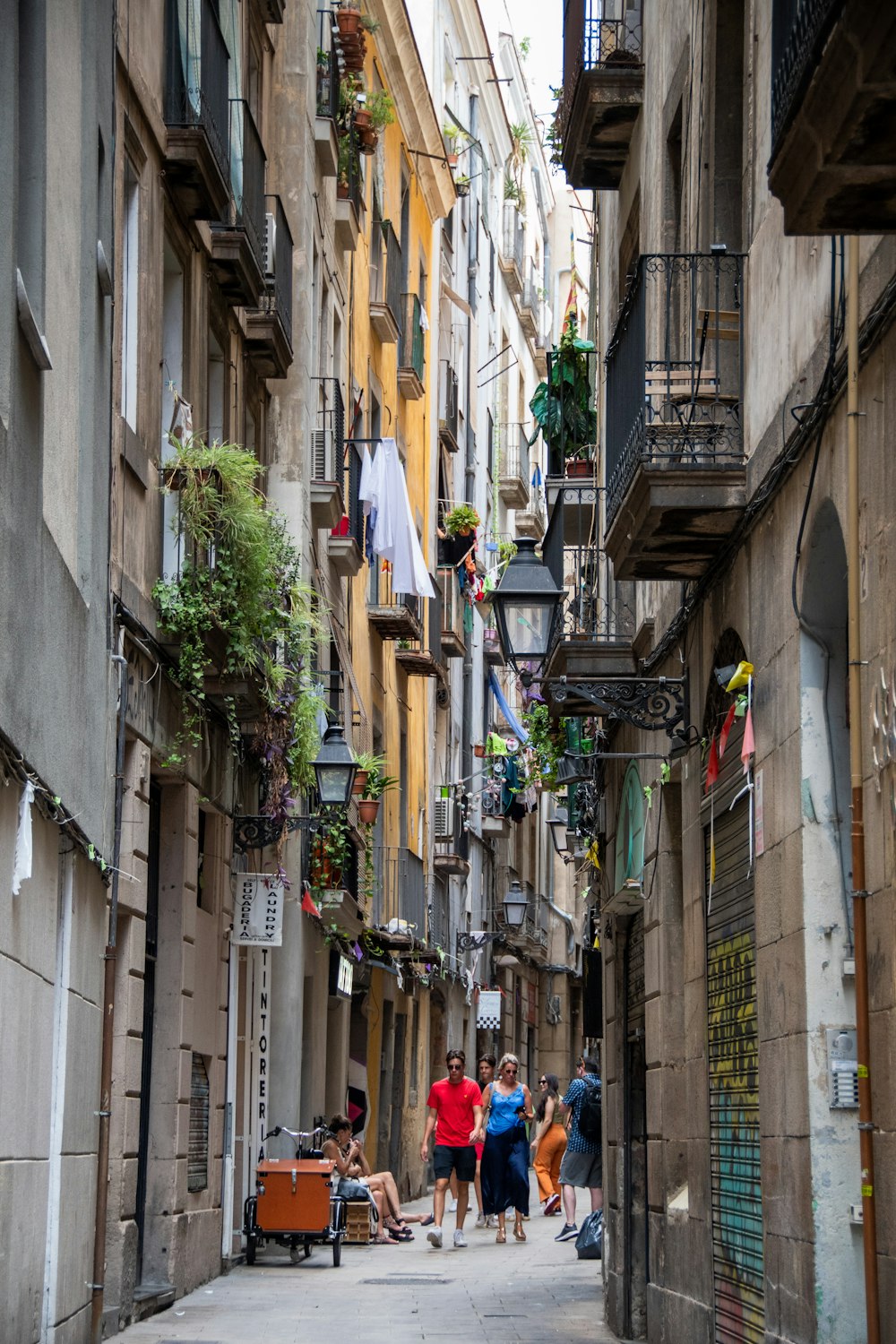 people walking down a narrow street