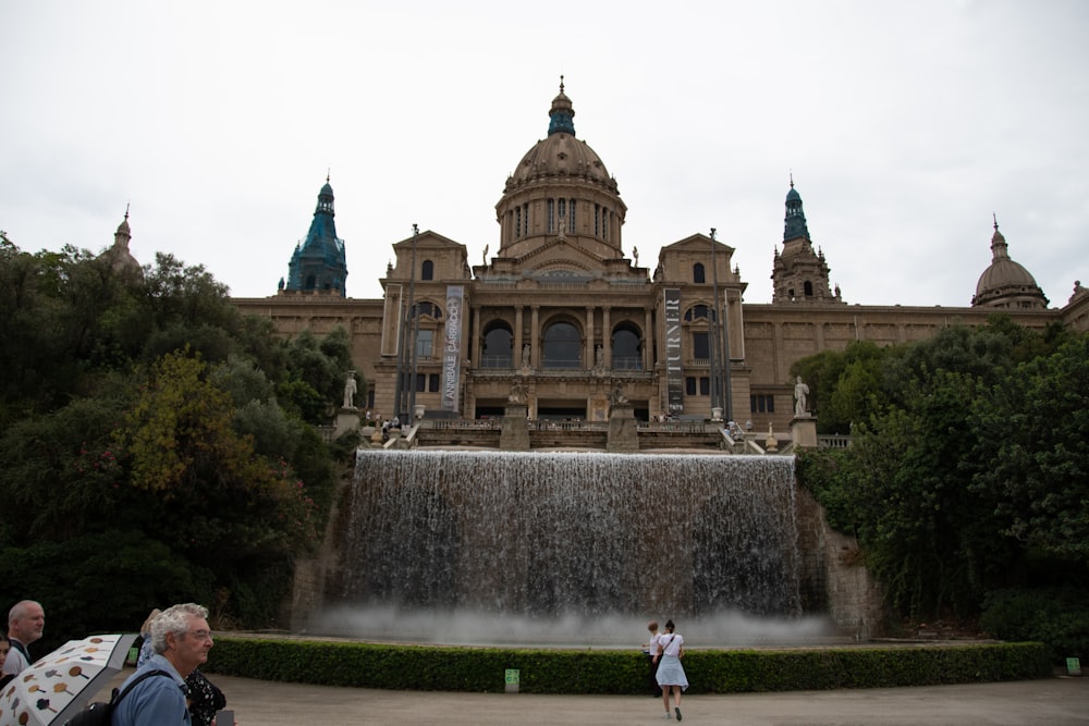 a large building with a fountain in front of it with Museu Nacional d'Art de Catalunya in the background