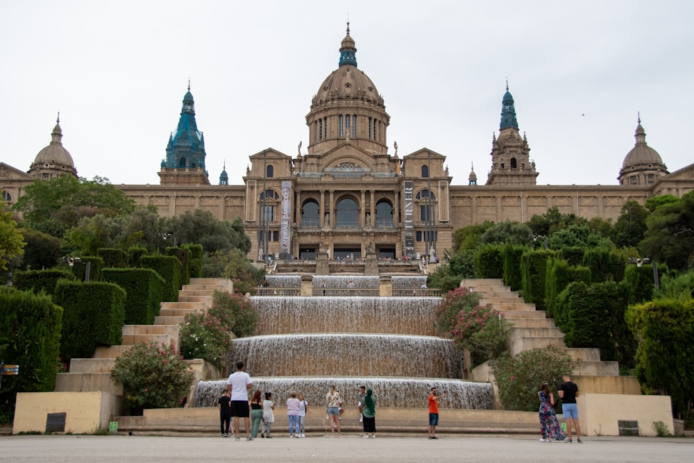 a large building with a fountain in front of it with Museu Nacional d'Art de Catalunya in the background