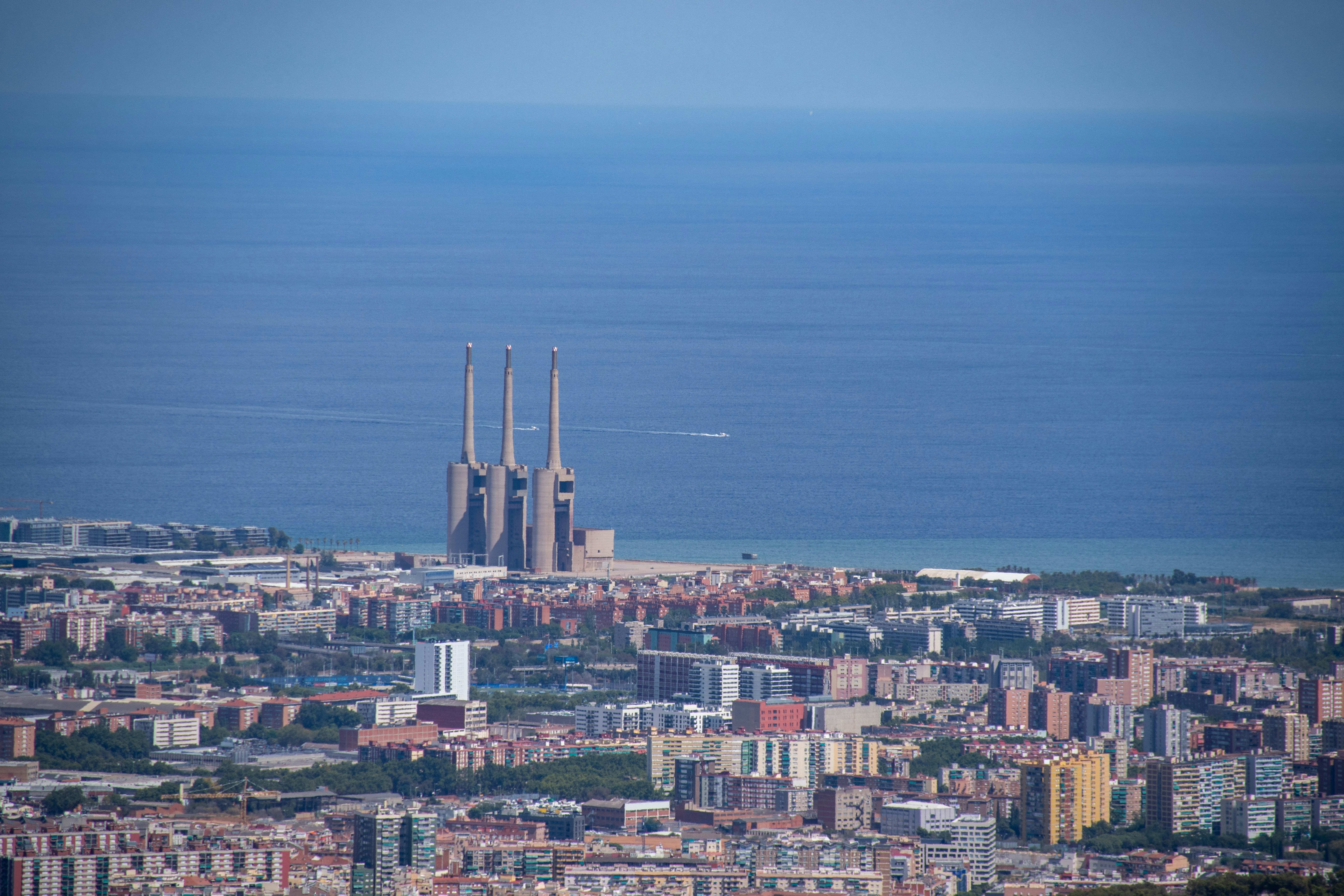 a city with a body of water in the background