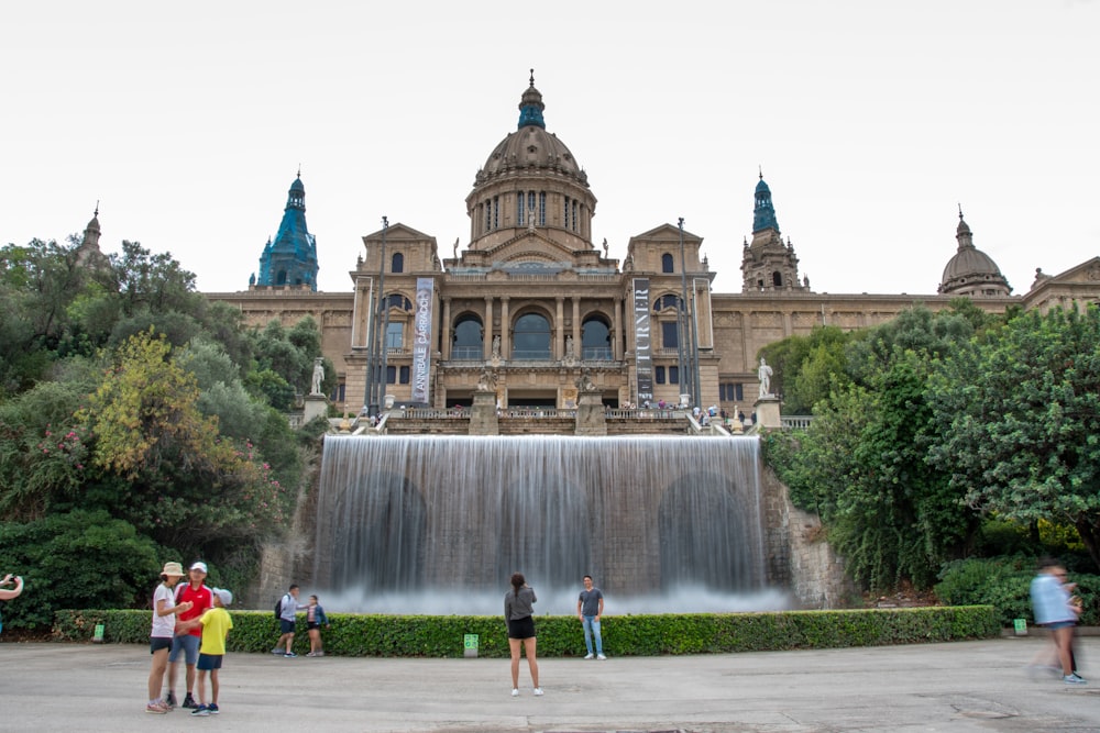 a large building with a fountain in front of it with Museu Nacional d'Art de Catalunya in the background