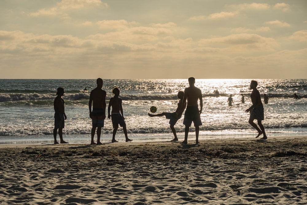 a group of people stand on a beach