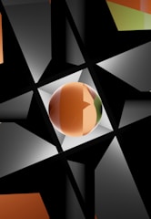 A geometric composition featuring intersecting black triangles and a central, glossy sphere. The sphere exhibits gradient colors ranging from orange to green. The background is a mix of dark and light gray triangles, creating an abstract and dynamic pattern.