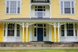 Charming exterior of a house painted in white with golden trim details.