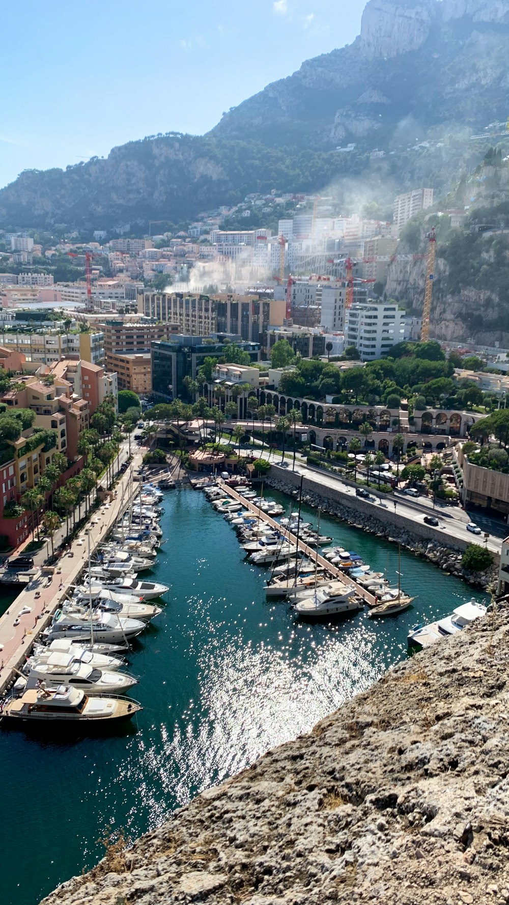 a river with boats on it and a city in the background