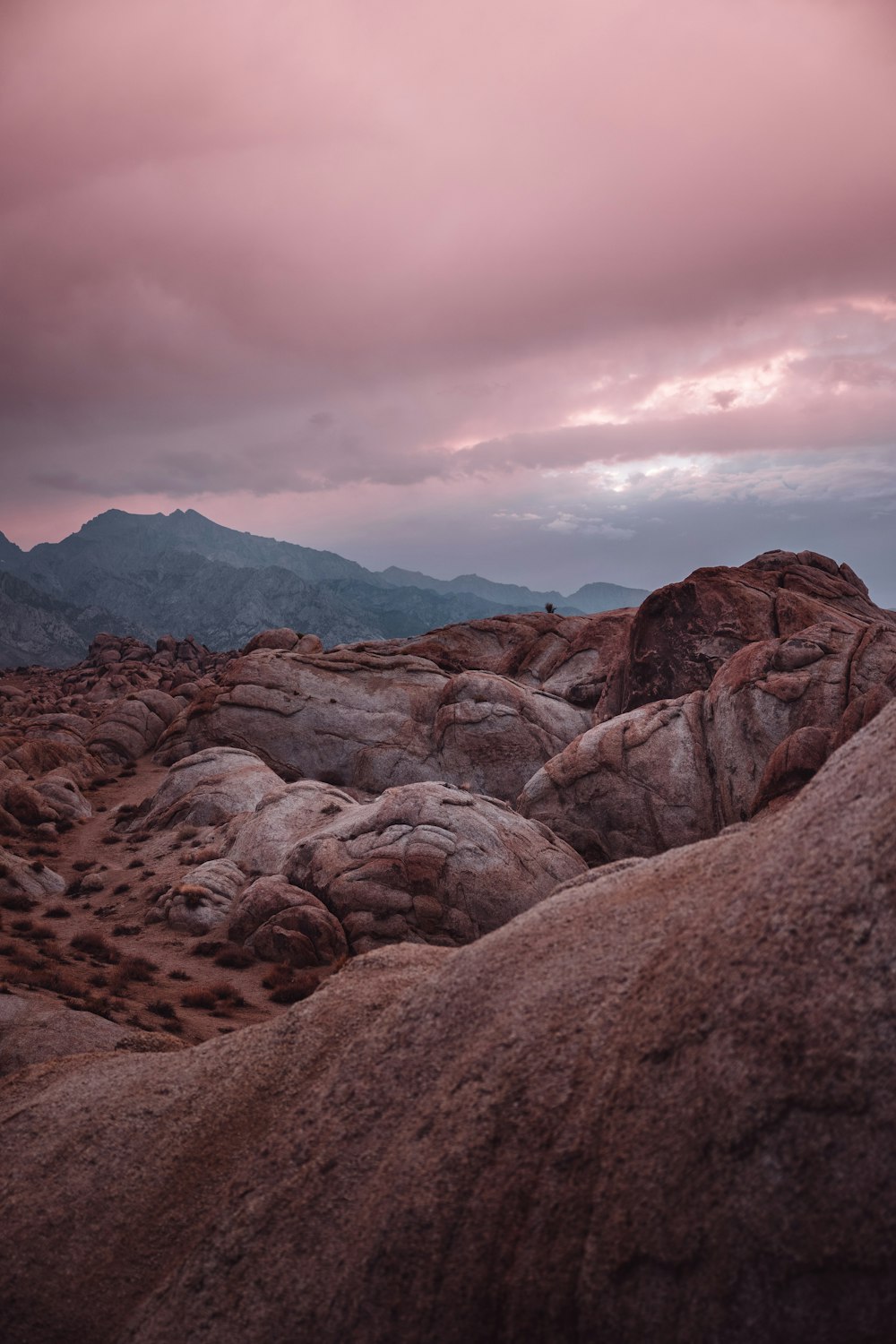 a rocky landscape with mountains in the background