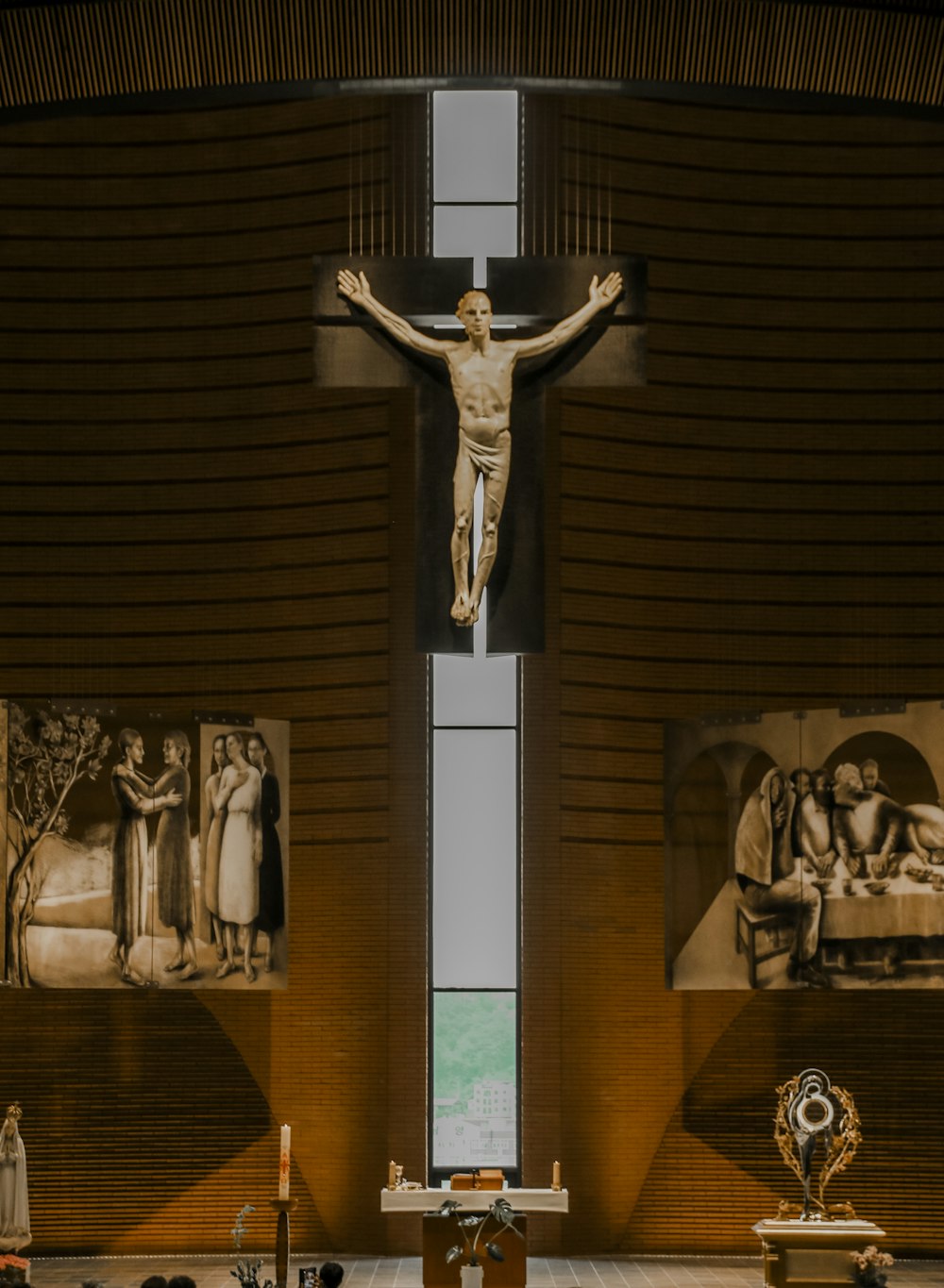 a statue of a person holding a cross