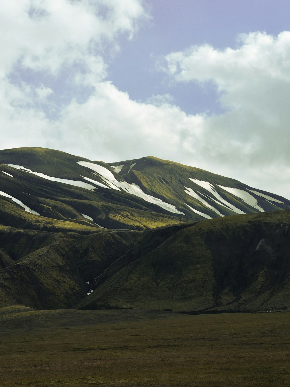 a mountain range with clouds