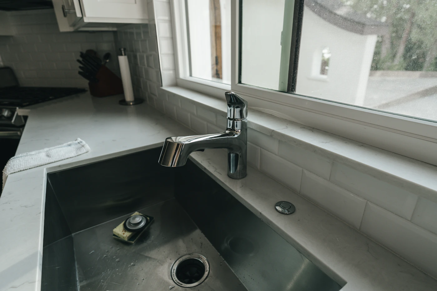Plumber repairing pipes under a sink
