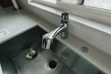 A sparkling kitchen countertop and sink after a deep cleaning session.