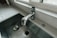 Photo of a neatly installed kitchen sink drain under a modern countertop.