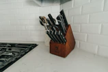 A sleek stainless steel knife block with sharp chef knives.