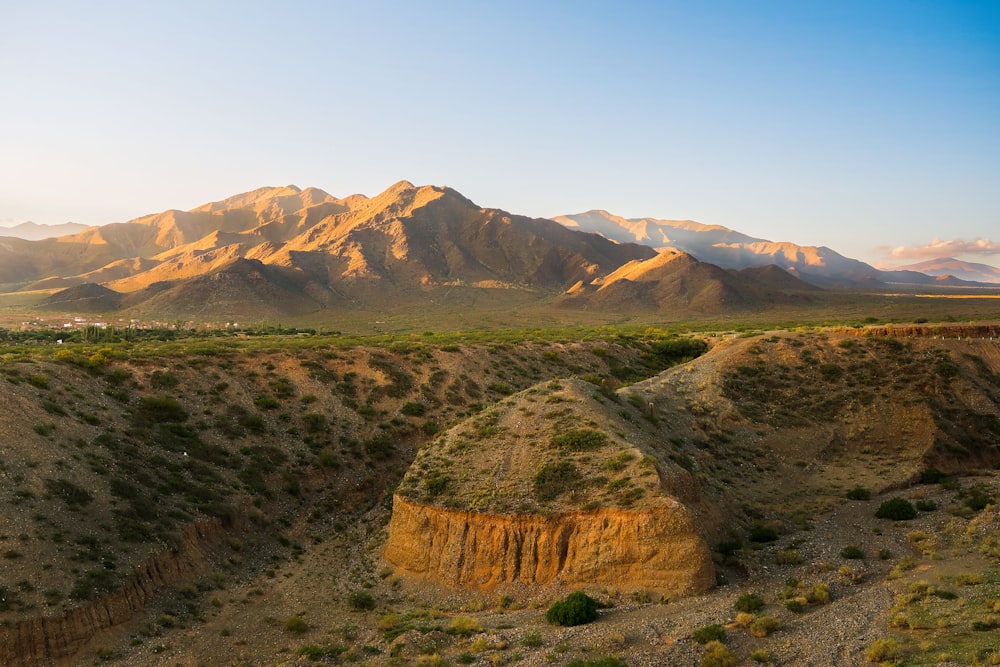 a landscape with mountains in the back